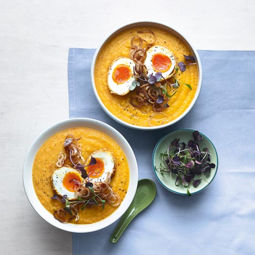 Carrot, swede and coconut soup with a crispy soft egg and shallots